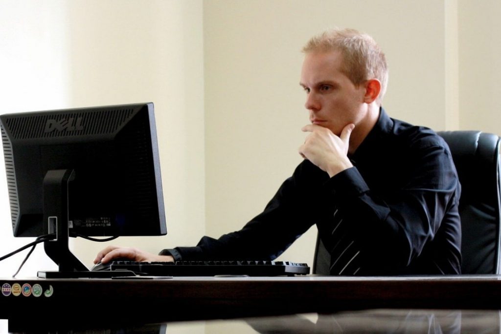 Ein Mann sitzt konzentriert vor seinem Bildschirm. 